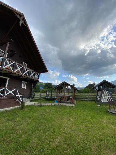 a group of buildings with a playground in a field at Кришталеві вершини in Vorokhta