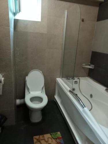 a bathroom with a toilet and a tub and a sink at apartament bloc joylife 18 in Costinesti