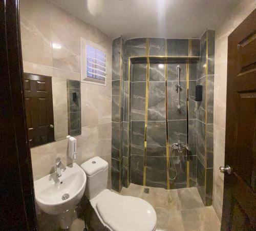 a bathroom with a shower and a toilet and a sink at TAN OTEL in Mersin