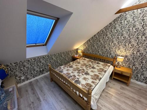 ein kleines Schlafzimmer mit einem Bett und einem Fenster in der Unterkunft Willa Bukówka Dom całoroczny w górach nad jeziorem in Miszkowice