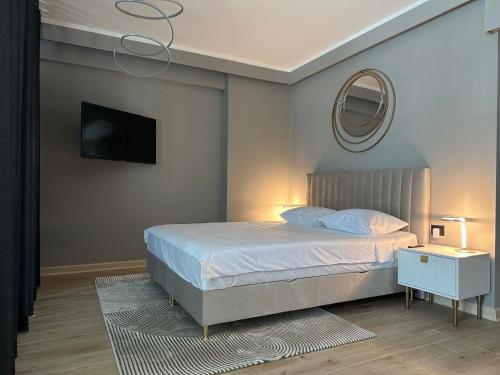 a bedroom with a bed with a mirror and a tv at Aqua Infinity- Pool & SPA Resort in Mamaia Nord
