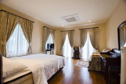 a bedroom with a bed and a piano and windows at Private Pool Villa & Golf - Toscana House Khaoyai 4 Bedrooms 10 Guests in Ban Rai Khlong Sai