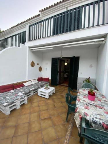 a room with tables and chairs and a staircase at Casa Montigar in Chiclana de la Frontera