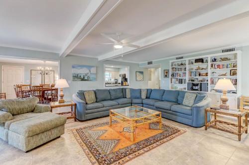 a living room with a blue couch and a table at Dog Friendly Beach House in Fernandina Beach
