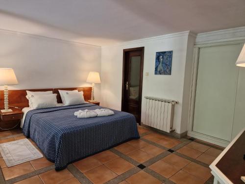 a bedroom with a bed with two pillows on it at Dream corner by waterfalls, 20 min to Oporto, by Porto with Love LDA in Parada