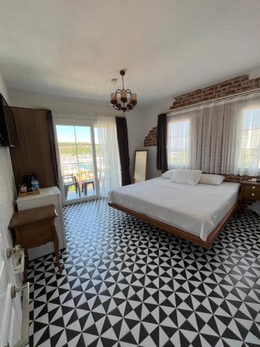 a bedroom with a bed and a black and white floor at Villa Veria in Çeşme