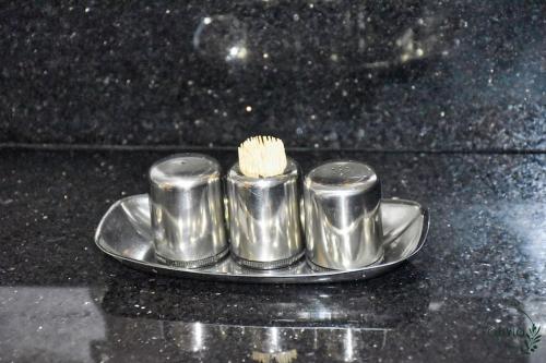 a silver plate with a toothbrush on top of a counter at Olivia By Atlantic in Agadir