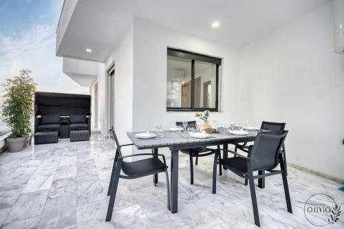 a dining room with a table and chairs at Olivia By Atlantic in Agadir