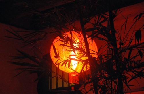 a orange light on a pole with a plant at Coffee Atelier in George Town