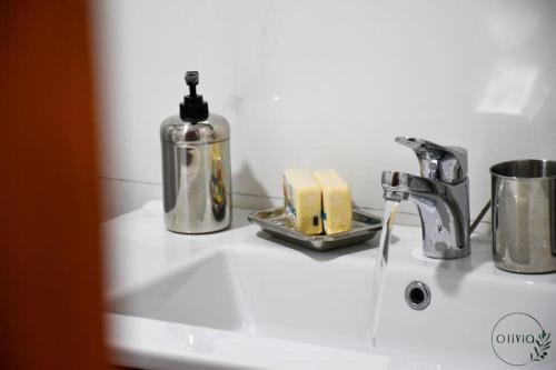 a bathroom sink with a soap dispenser and a bottle of soap at Olivia By Atlantic in Agadir