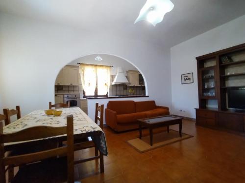 a living room with a table and a couch at Il Villino in Platamona