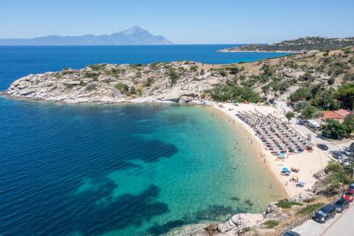 an aerial view of a beach with chairs and umbrellas at Morfo Luxury Living in Sikia