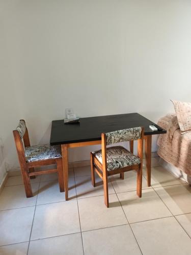 a black table and two chairs and a table and a couch at Kaedo in Corrientes