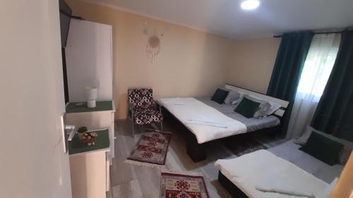 a small room with a bed and a couch at Centrala in Vrdnik