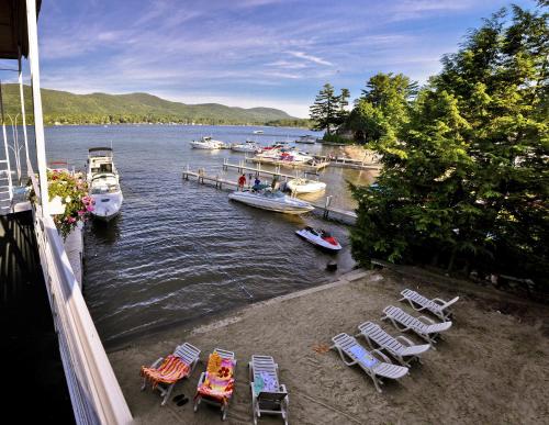 a group of chairs and boats on a body of water at Lake Crest Inn in Lake George