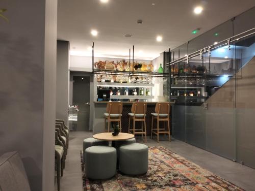 a bar with a table and chairs in a room at Villa Rey Spa & Hotel in Vila de Rei