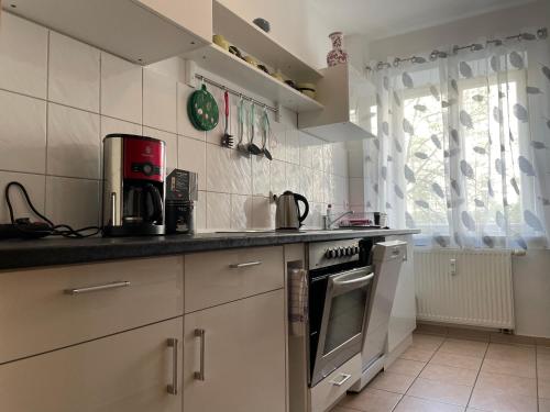 a kitchen with a sink and a stove top oven at Sueños Apartment in Magdeburg