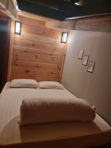 a bedroom with a bed with a wooden wall at Ayder Rainbow Gokkusagi in Ayder Yaylasi