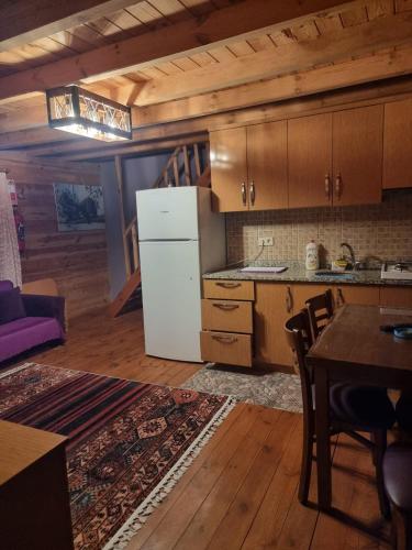 a kitchen with a white refrigerator and a table at Ayder Rainbow Gokkusagi in Ayder Yaylasi