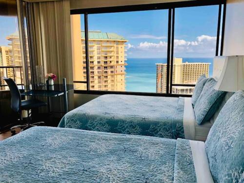 a hotel room with two beds and a large window at Waikiki Panoramic Ocean View in Honolulu