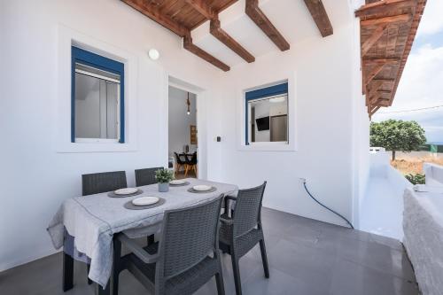 a dining room with a table and chairs at Anzuelo Apartments in Megalochori