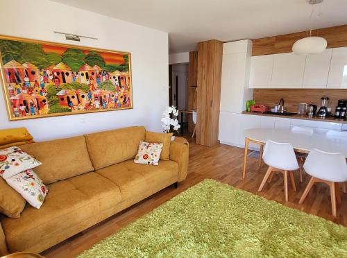a living room with a couch and a table at Apartament Comfort Del Mar II Kolobrzeg in Kołobrzeg