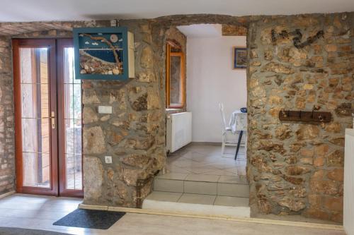 a room with a stone wall and a door at Casa Angelo in Nerezine