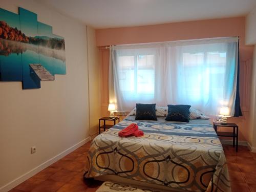 a bedroom with a bed and a large window at AMRoom - Santander in Santander