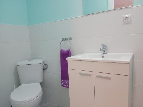 a bathroom with a white toilet and a sink at AMRoom - Santander in Santander