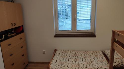 a bedroom with a bed and a window at Ubytovanie u Grošíka in Oščadnica