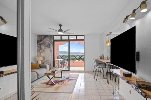 a living room with a view of the ocean at Duplex standing et confort - Baby ready - 2 minutes de la plage Anse Mitan in Les Trois-Îlets