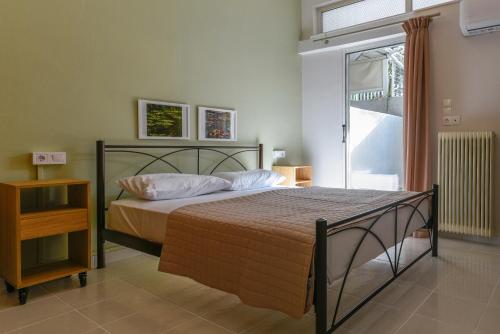 a bedroom with a bed and a window at Coastal Getaway: Roomy Beachside Apartment! in Nea Makri