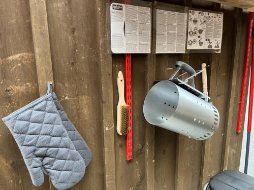 a wooden fence with a dustpan and a tool at Tiny Haus Dornbirn in Dornbirn
