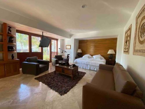 a large living room with a bed and a couch at Beautiful beach front apartment in Ixtapa. in Ixtapa