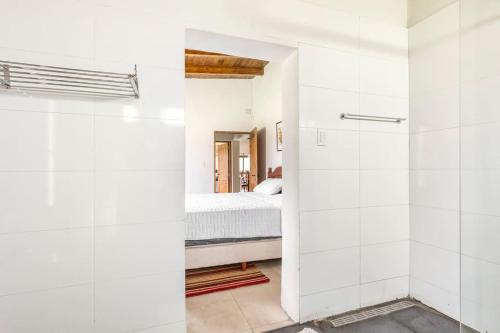 a bathroom with white walls and a bed in a room at Calivista Vineyard in Tunuyán