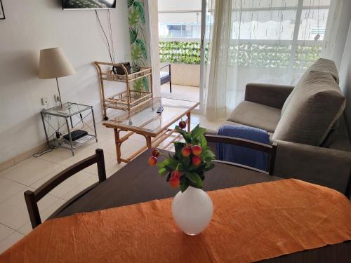 a living room with a table with a vase on it at ESPIGALL in Vilanova i la Geltrú