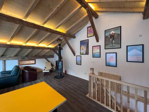 a living room with a yellow table on the wall at Chalet Des Legendes in La Combe