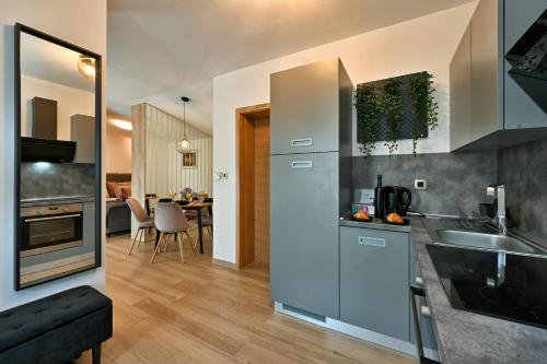 a kitchen with a sink and a counter top at Tonka studio apartman in Križevci