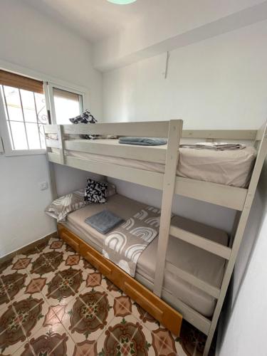 a bedroom with two bunk beds in a room at NICE APARTAMEN in Lloret de Mar