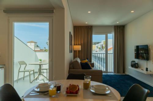 a living room with a couch and a table in a room at Downtown PDL Premium in Ponta Delgada