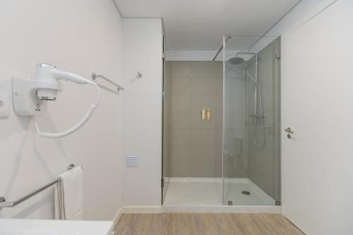 a shower with a glass door in a bathroom at Downtown PDL Premium in Ponta Delgada