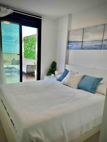 a bedroom with a large bed with a view of the ocean at Rincón Idilia (Málaga). in Rincón de la Victoria