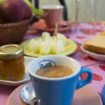 a cup of coffee on a table with plates of food at B&B Da Giua' in Apricale