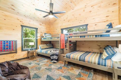 a bedroom with two bunk beds in a wooden cabin at Blackberry Chalet in Sevierville