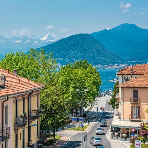 a view of a street in a town with mountains at Labiena Lake Maggiore in Laveno