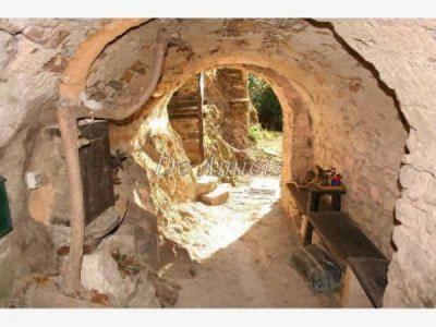 an archway in a stone building with a bench at B&B Da Giua' in Apricale