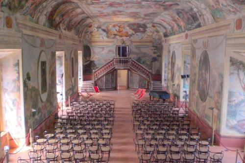 an empty auditorium with chairs and paintings on the ceilings at Cosy Hill Home Rucman With a Breathtaking View in Zgornja Pohanca