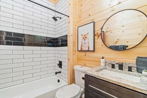 a bathroom with a dog picture on the wall at Blackberry Chalet in Sevierville