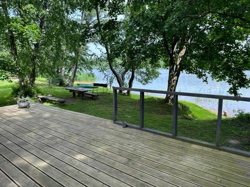 Vārve的住宿－Vecliepas，木甲板设有围栏和野餐桌