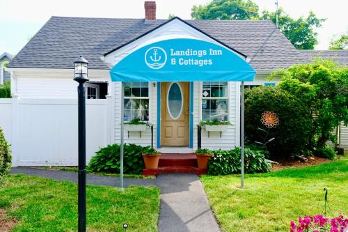 a house with a blue tent in front of it at The Landings Inn and Cottages at Old Orchard Beach in Old Orchard Beach